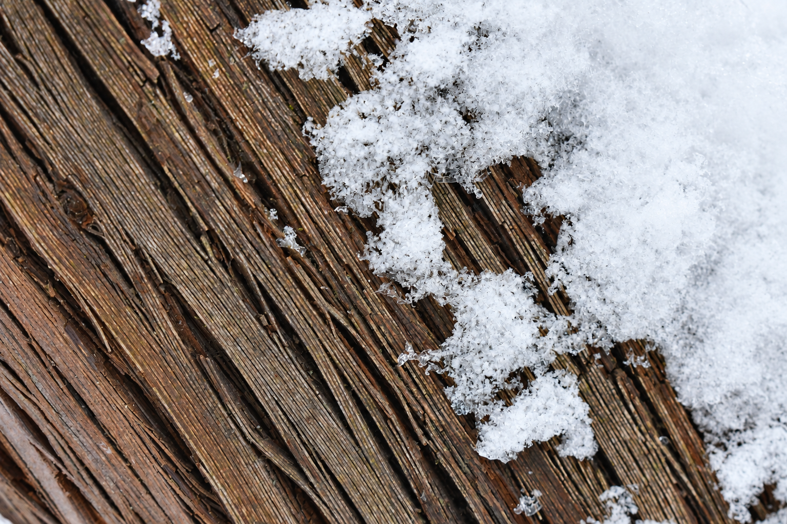 Snow crystals on weathered wooden boards